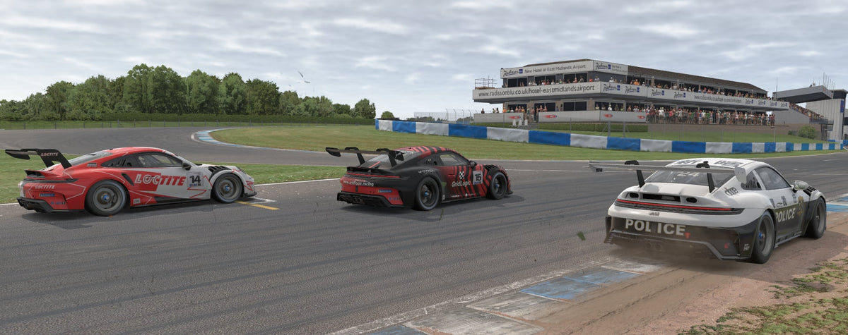 Three GT race cars on track, including a Grid Logic car numbered 15.